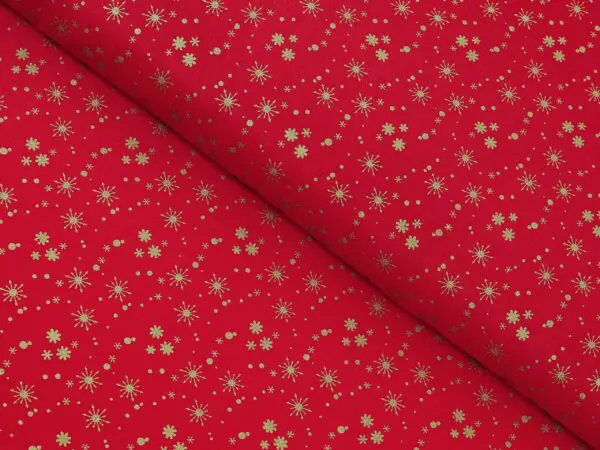 Bavlněná látka zlaté vločky na červené metráž šířka 142 cm značky Škodák.