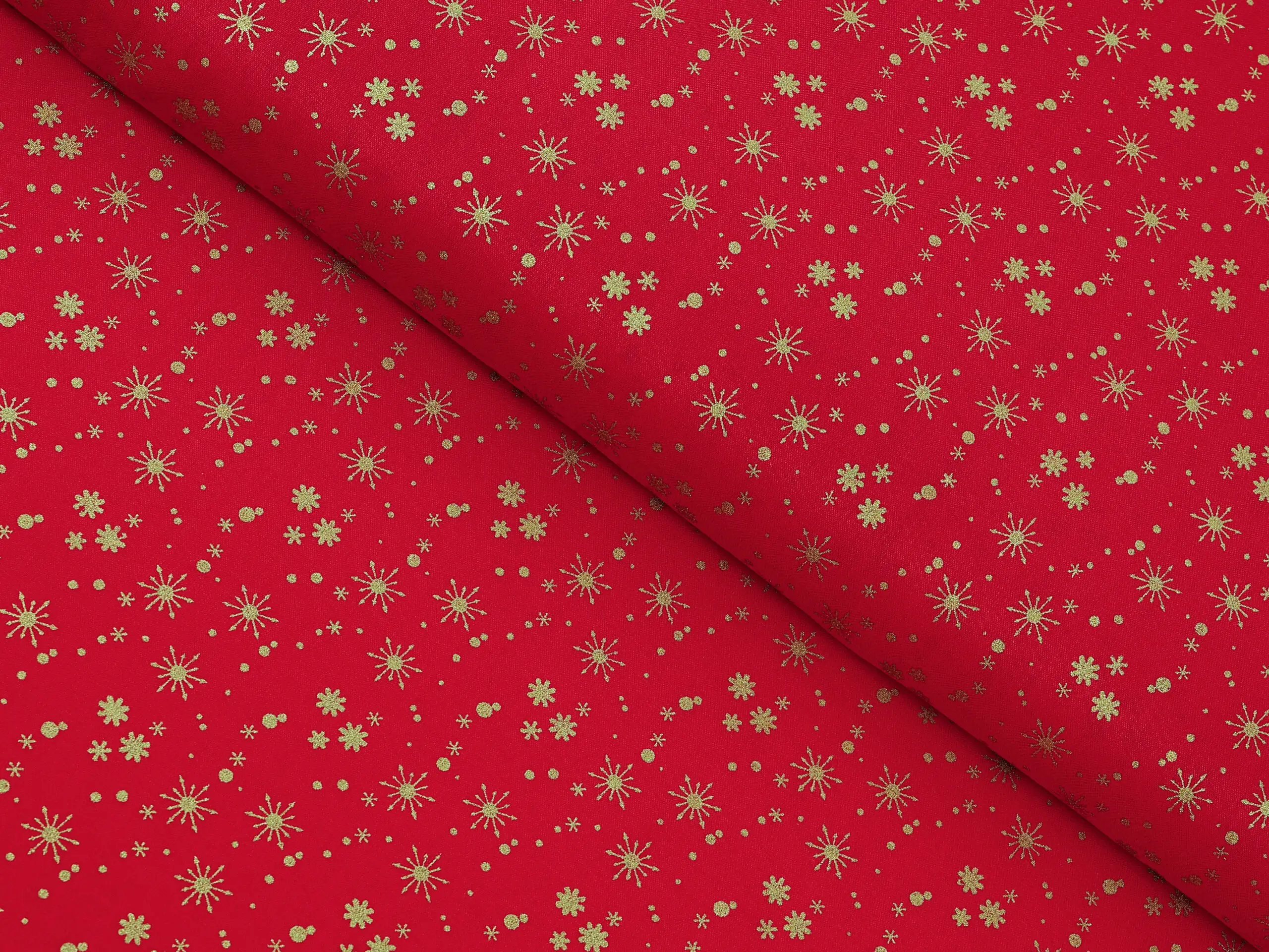 Bavlněná látka zlaté vločky na červené metráž šířka 142 cm značky Škodák.