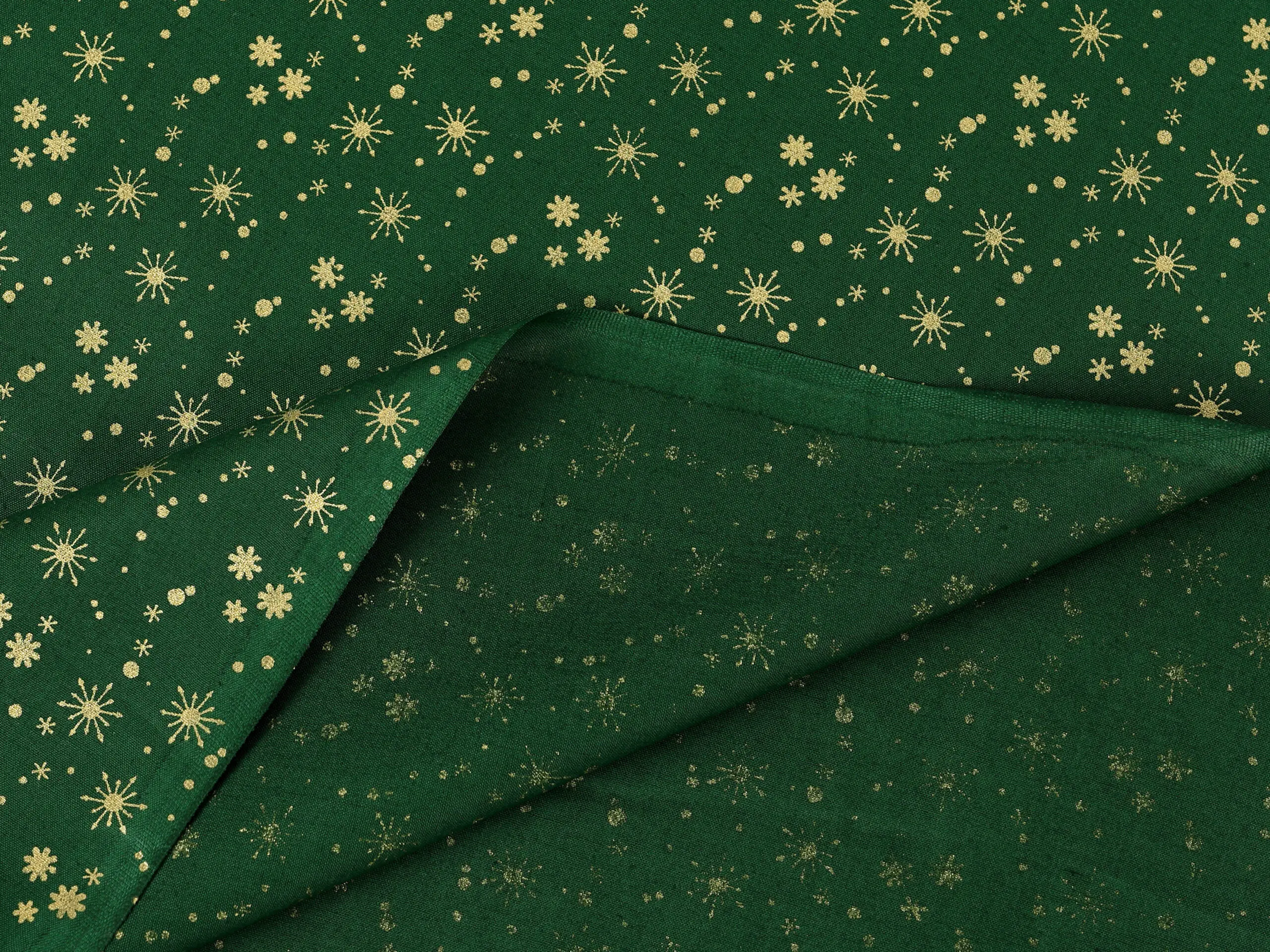 Bavlněná látka zlaté vločky na zelené metráž šířka 142 cm značky Škodák.