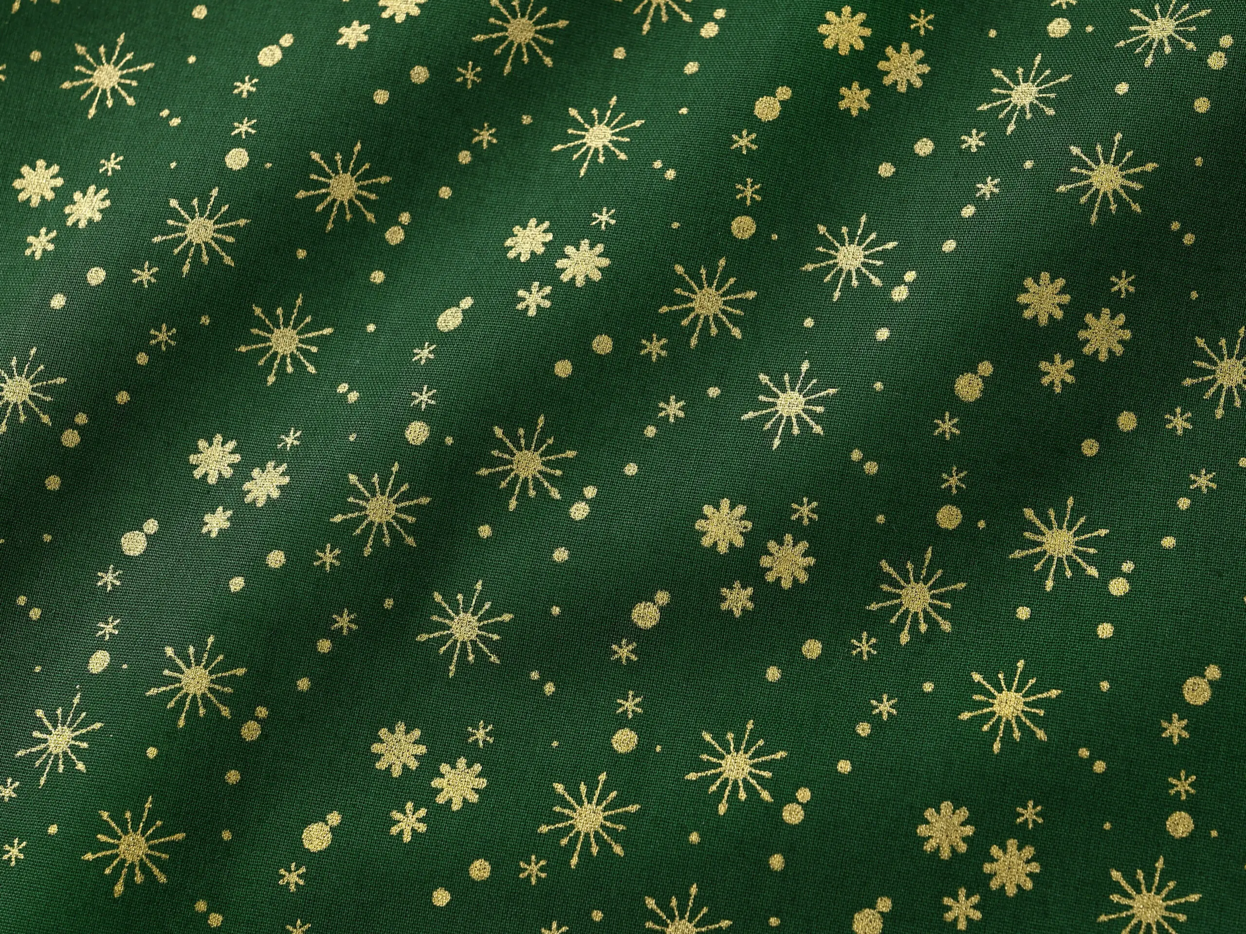 Bavlněná látka zlaté vločky na zelené metráž šířka 142 cm značky Škodák.